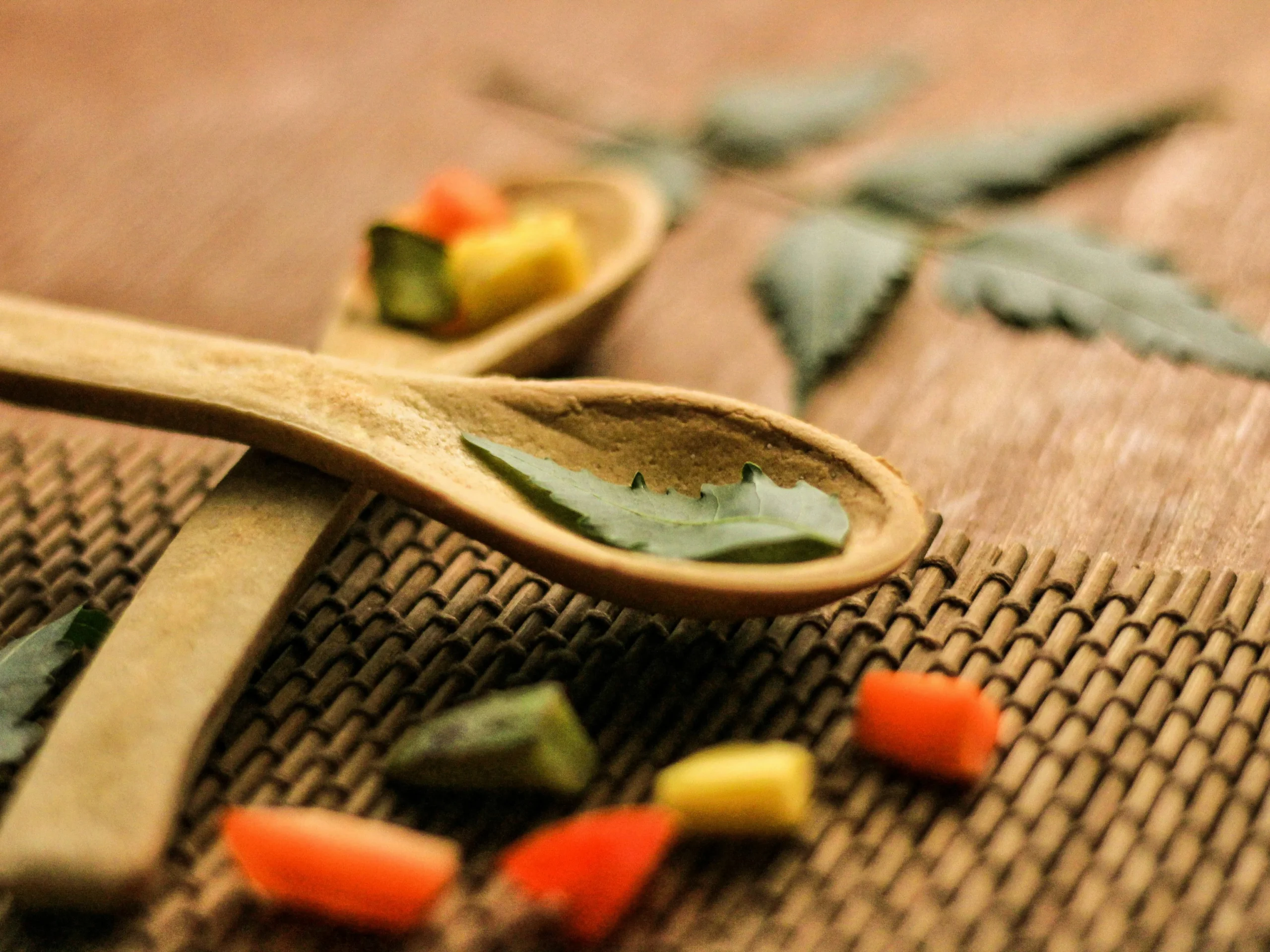 Close-up of CBD oil and gummies with natural hemp leaves, representing legal Ayurvedic wellness products